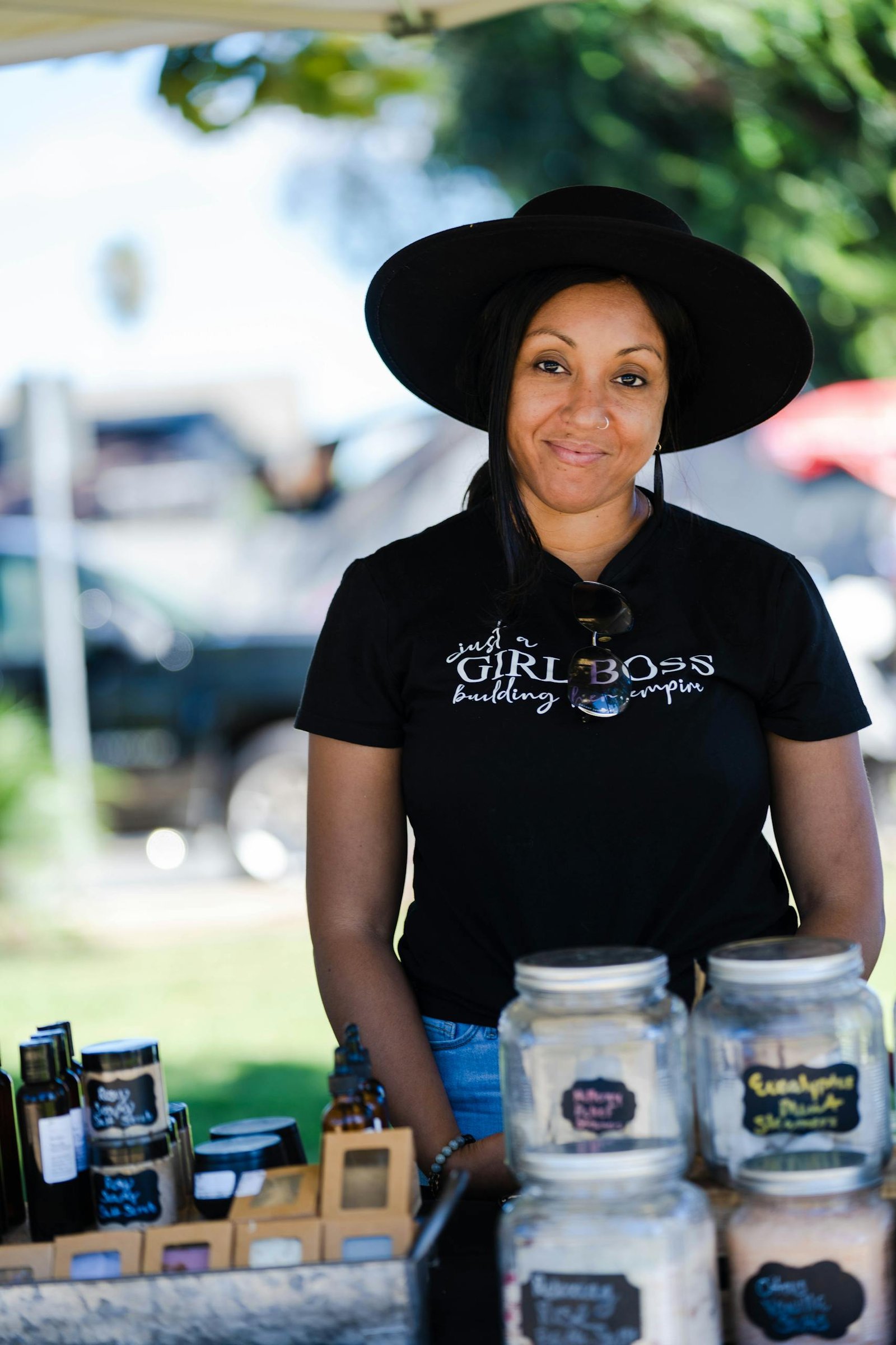Entrepreneur showcasing handmade goods at a vibrant outdoor market.